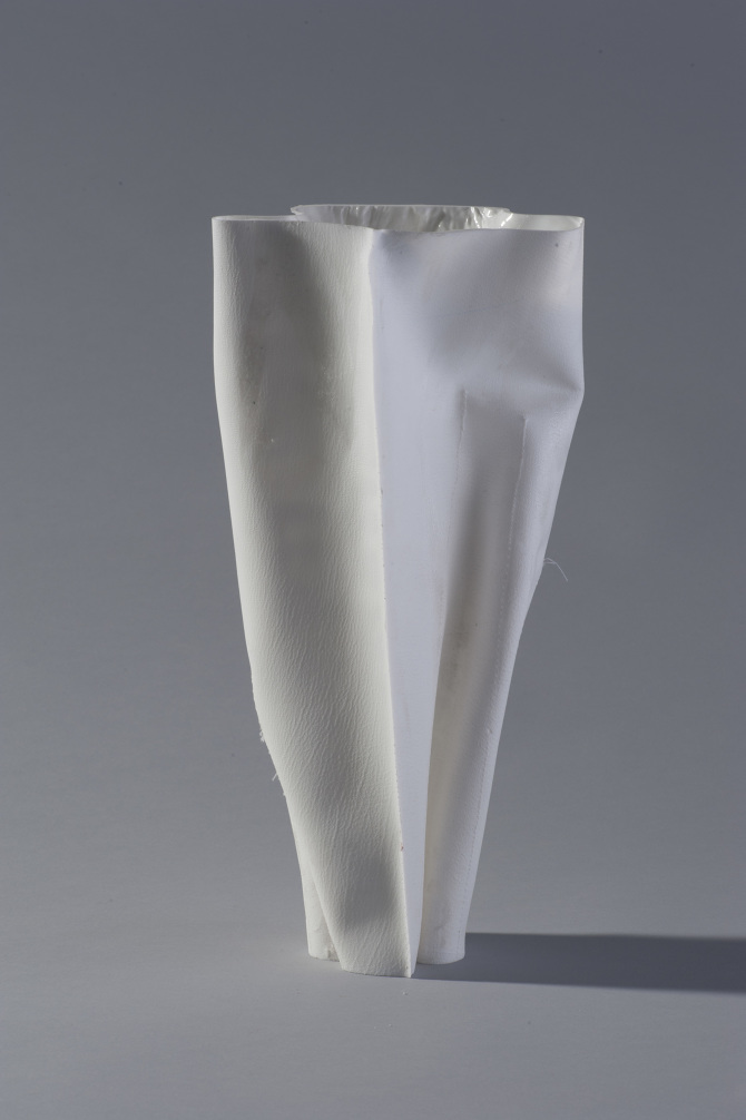 White twisted conical sculptural form, studio lit against gray background